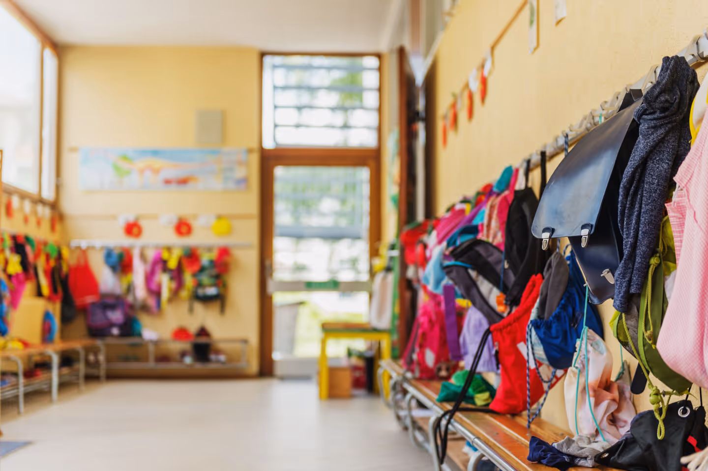 kids bags collected on the wall at a daycare